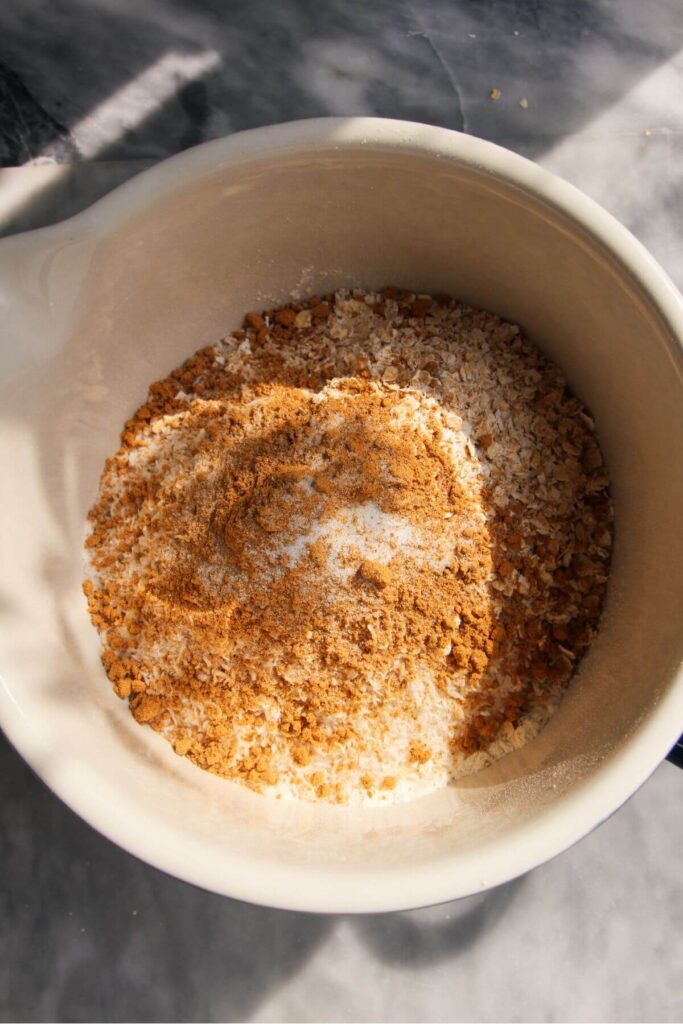 Dry ingredients added to a white mixing bowl.