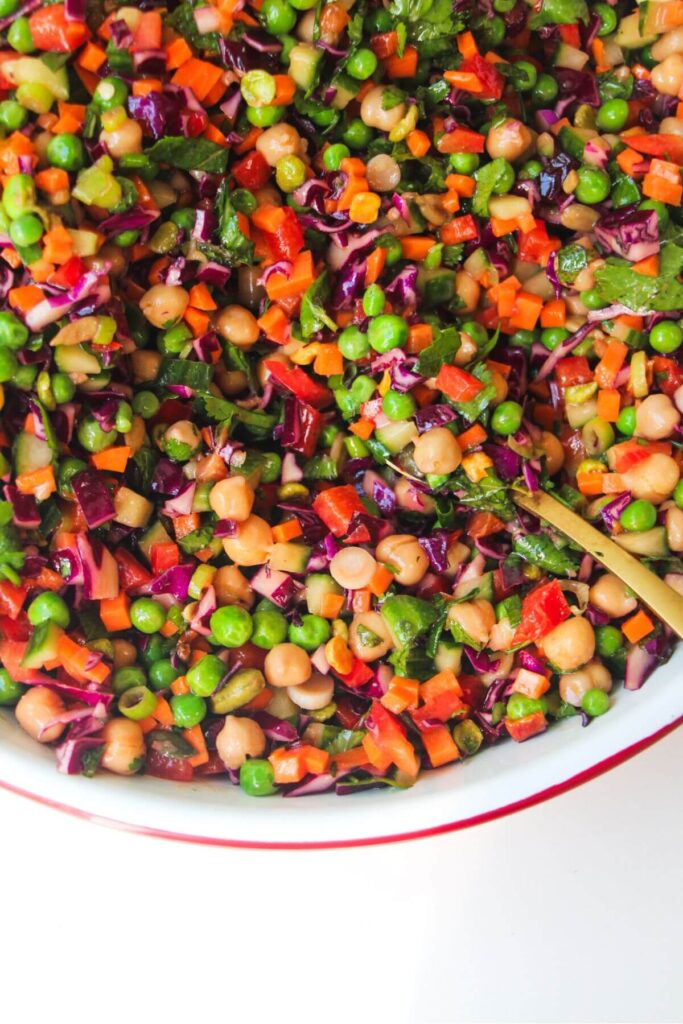 Close up of rainbow chopped salad in a large bowl.