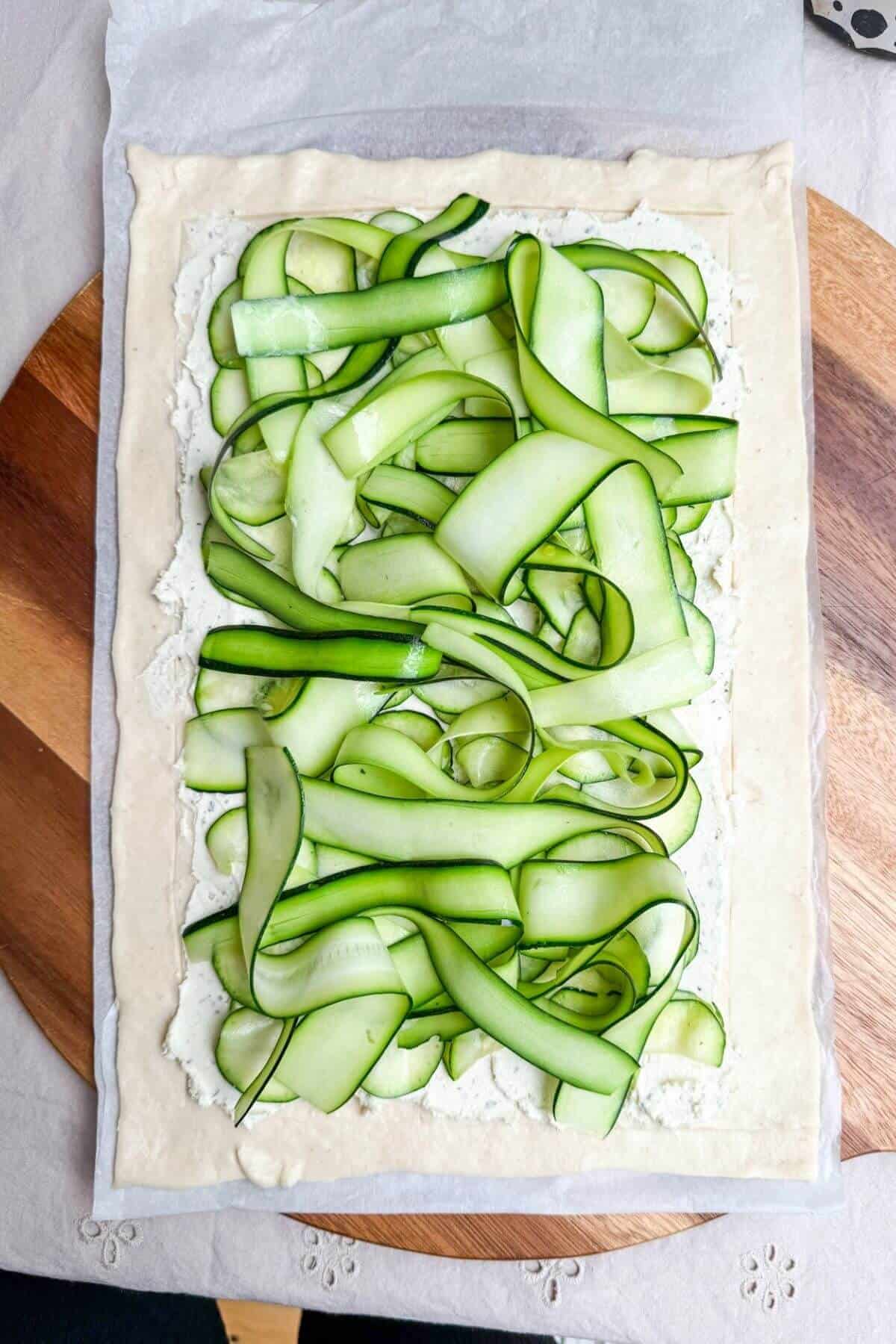 Zucchini piled onto Boursin on puff pastry.