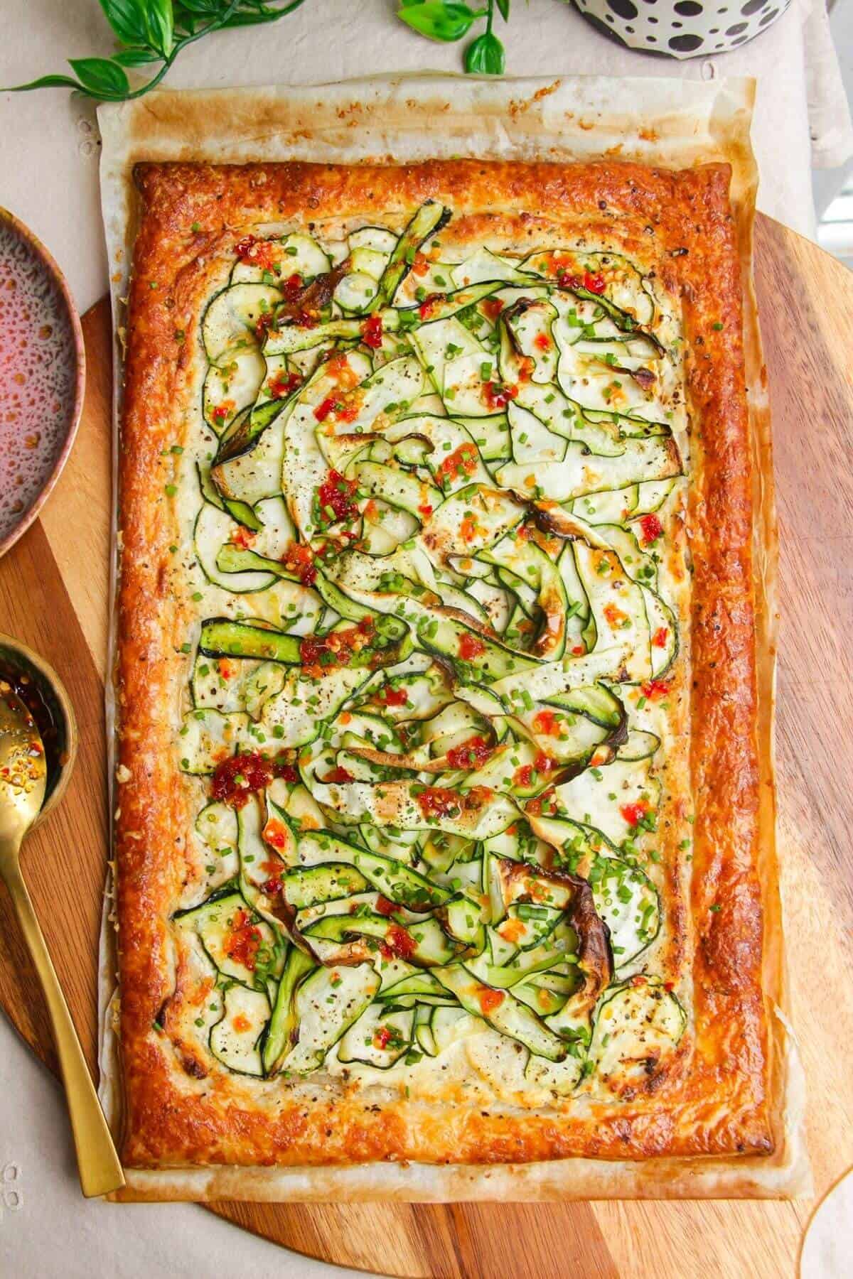 Zucchini tart topped with sweet chili and herbs.