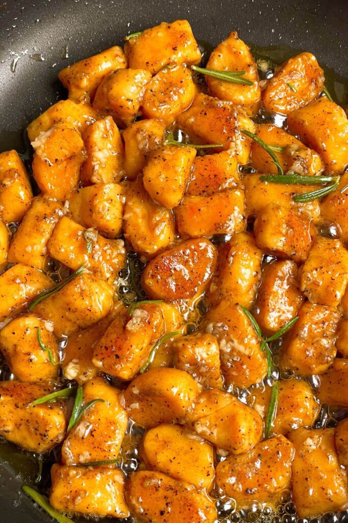 Close up of sweet potato gnocchi in brown butter sauce.