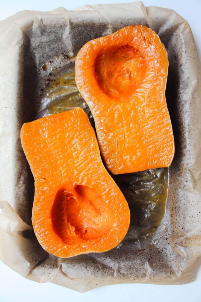 Soft roasted squash on a lined oven tray.