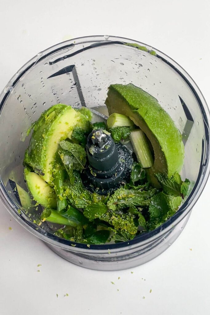 Ingredients for whipped avocado in a small food processor.