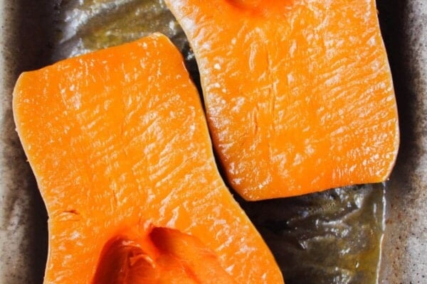 Soft roasted squash on a lined oven tray.