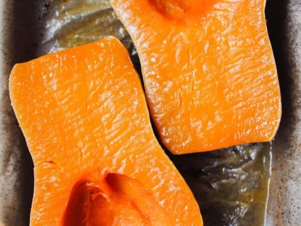 Soft roasted squash on a lined oven tray.