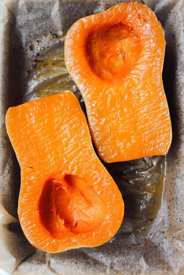Soft roasted squash on a lined oven tray.