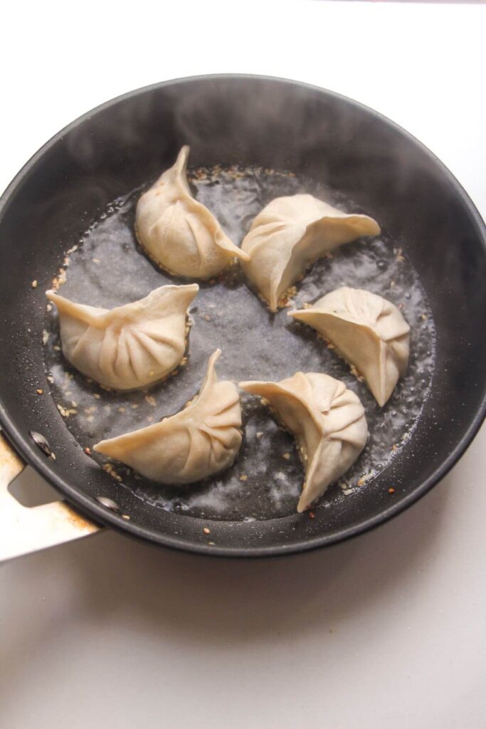 Six dumplings in a small pan..