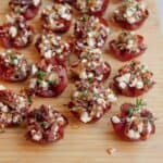 Loaded crispy salami bites on a wooden board.