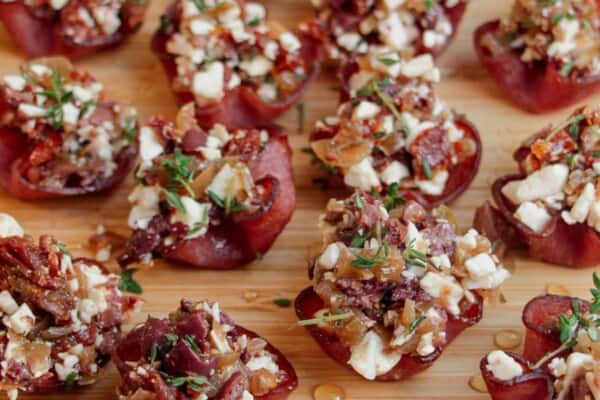 Loaded crispy salami bites on a wooden board.
