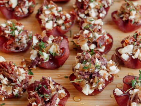 Loaded crispy salami bites on a wooden board.