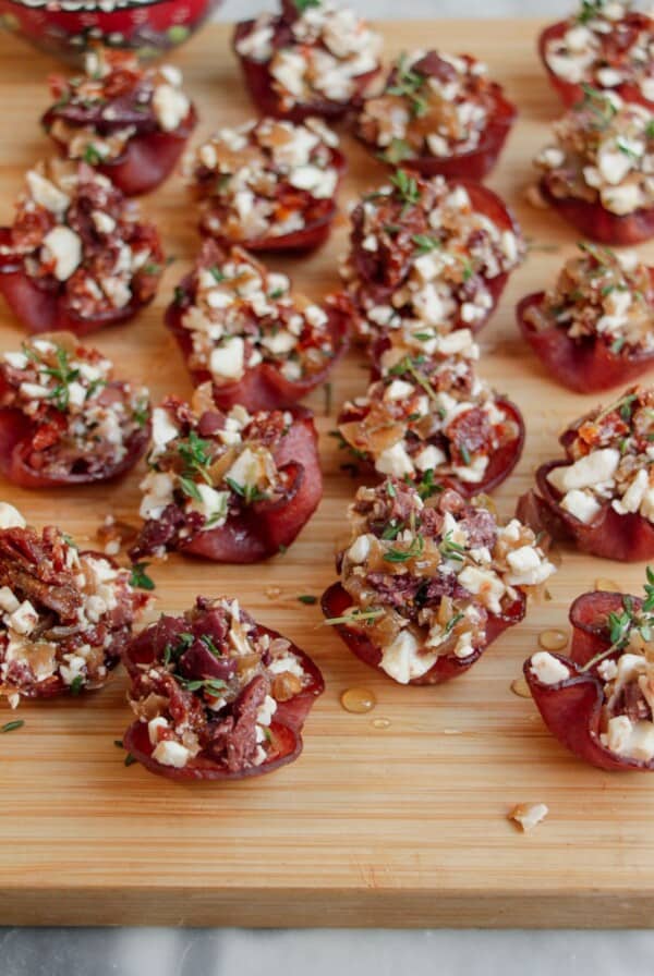 Loaded crispy salami bites on a wooden board.