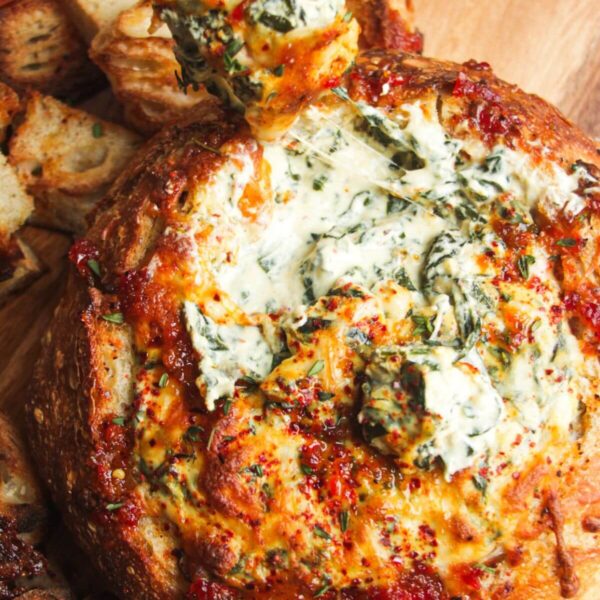 Cheesy spinach dip in a bread bowl.