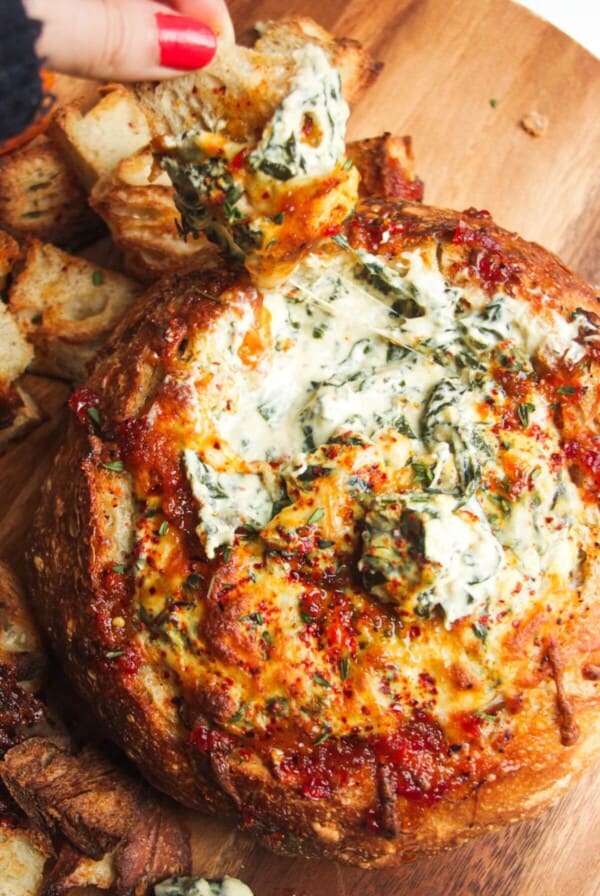 Cheesy spinach dip in a bread bowl.
