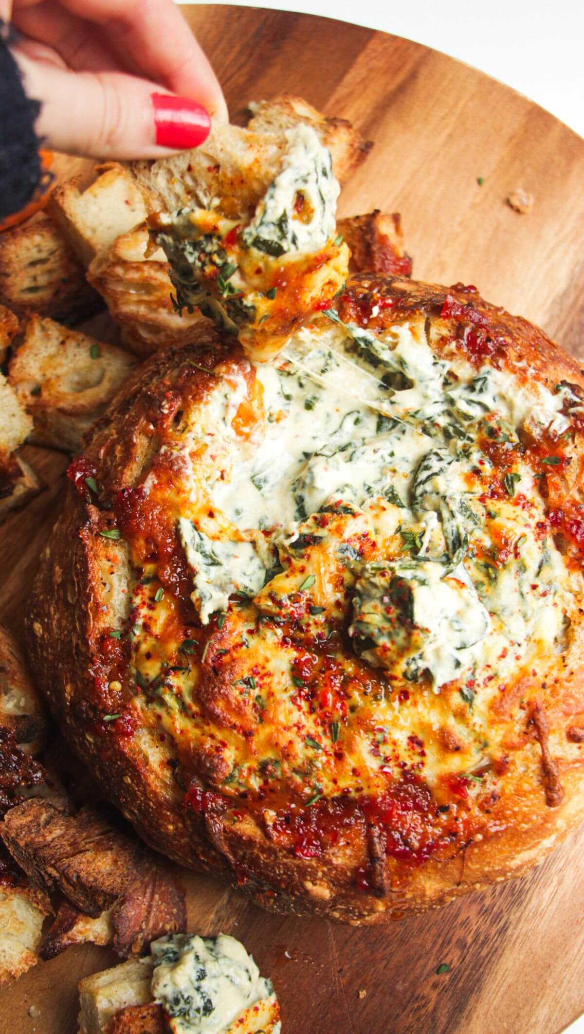 Cheesy spinach dip in a bread bowl.