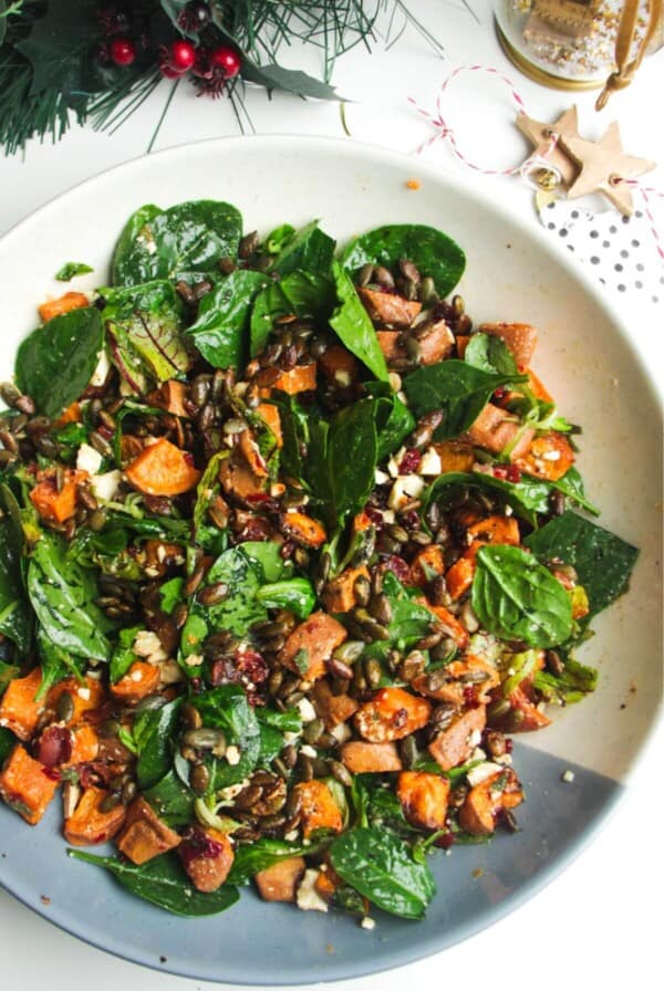 Roasted sweet potato salad in a large white and blue bowl.