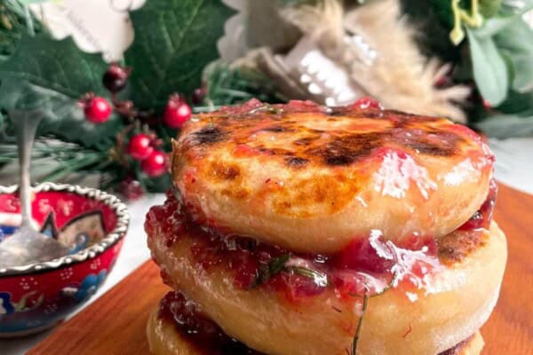 Stack of brie stuffed flatbreads drizzled with cranberry butter.