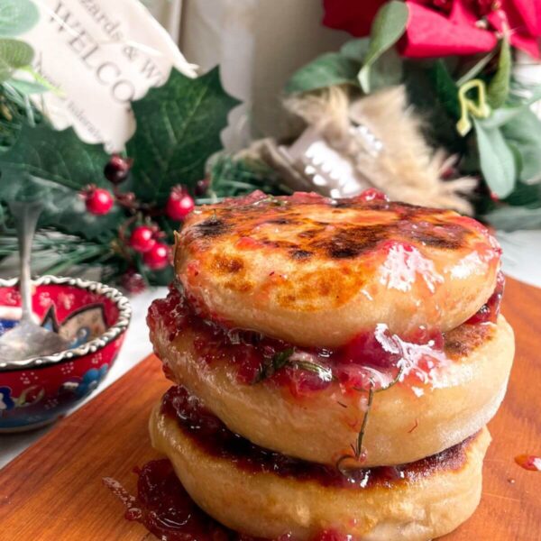 Stack of brie stuffed flatbreads drizzled with cranberry butter.