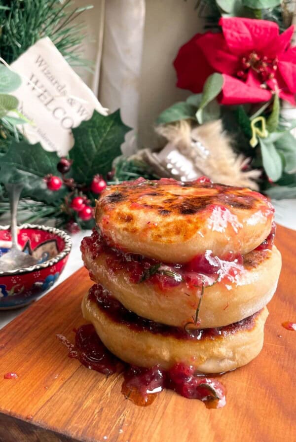 Stack of brie stuffed flatbreads drizzled with cranberry butter.
