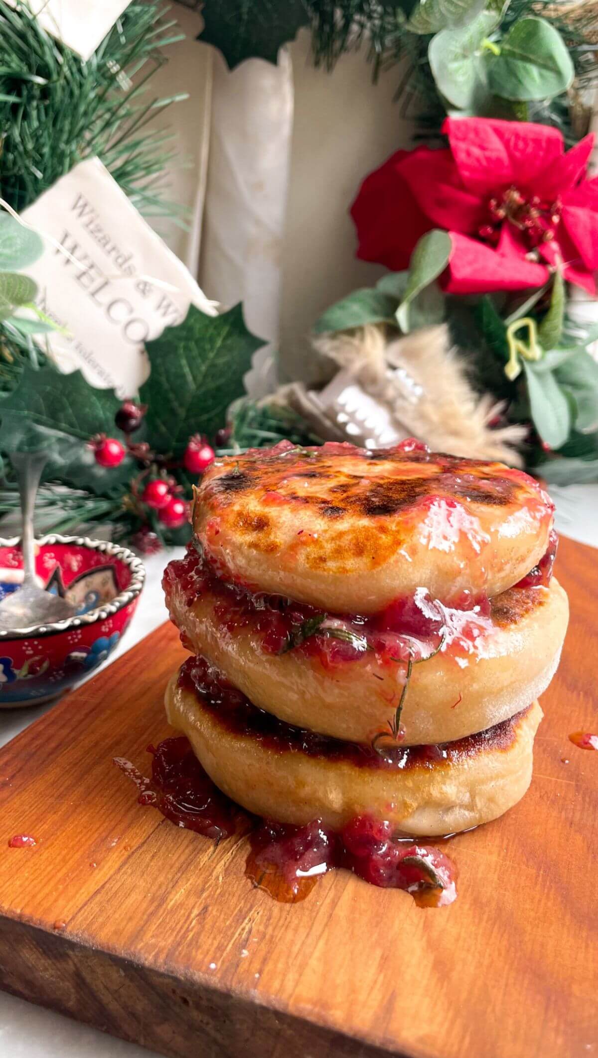 Stack of brie stuffed flatbreads drizzled with cranberry butter.