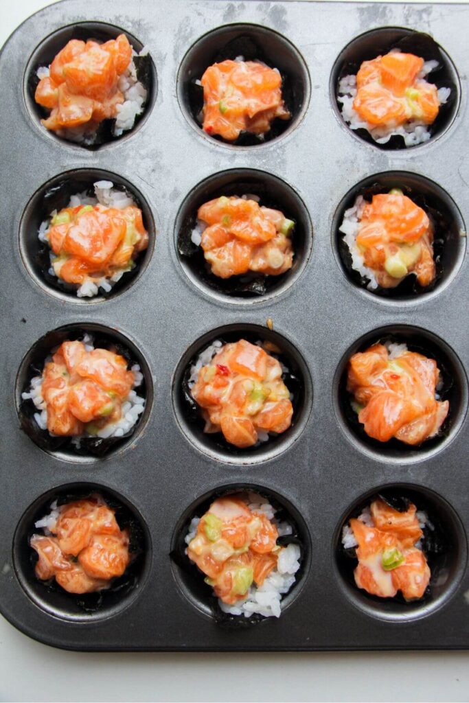 Salmon sushi bites in a mini muffin tin.