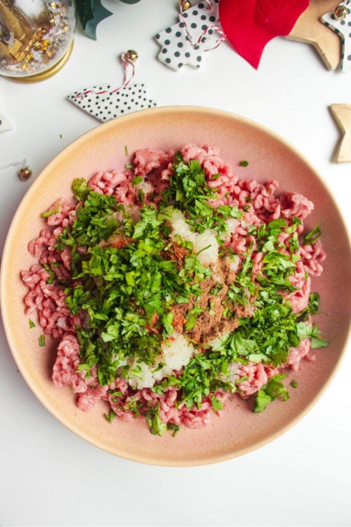 Meatball ingredients in a pink bowl.