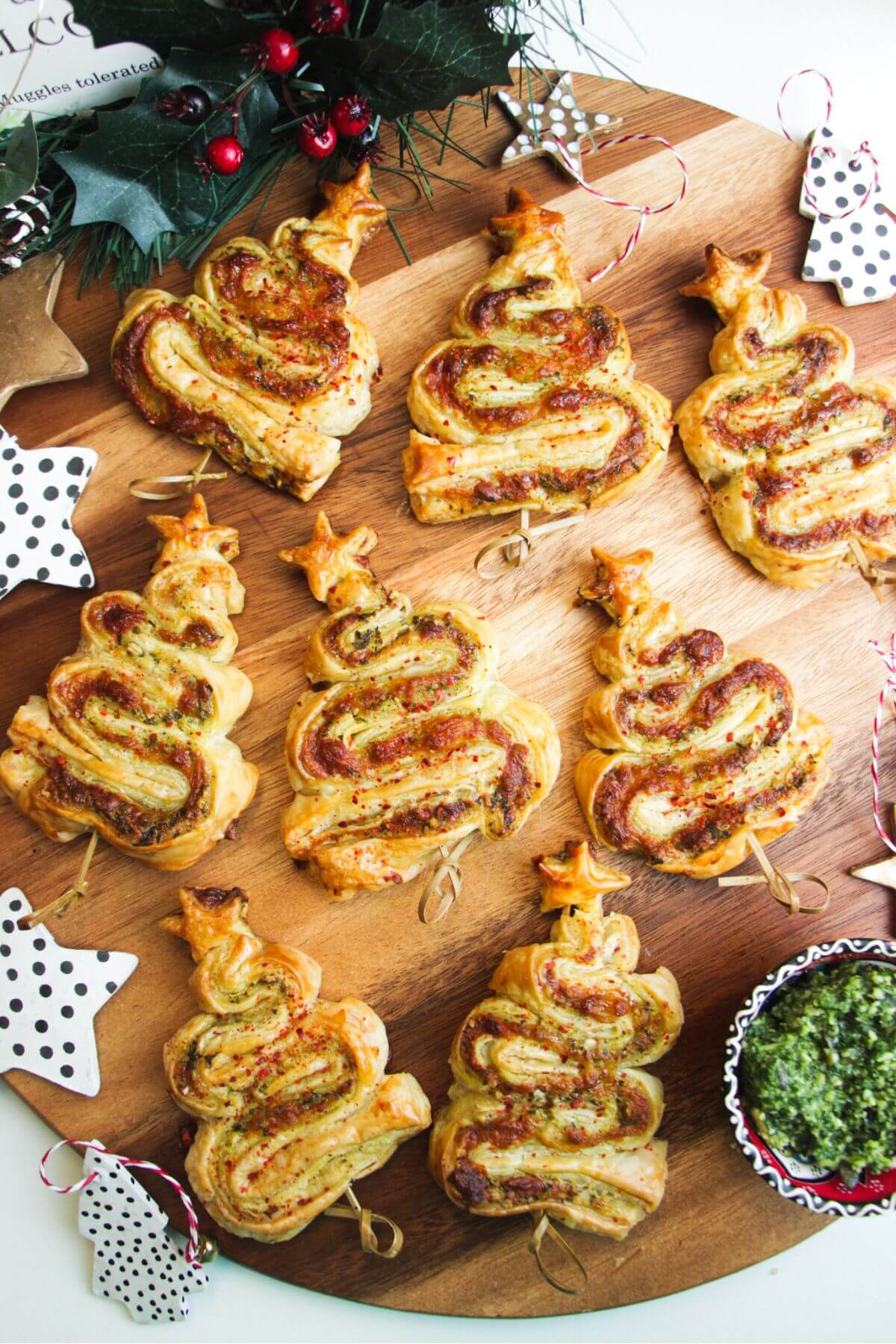 Pesto puff pastry Christmas trees on a wooden board.