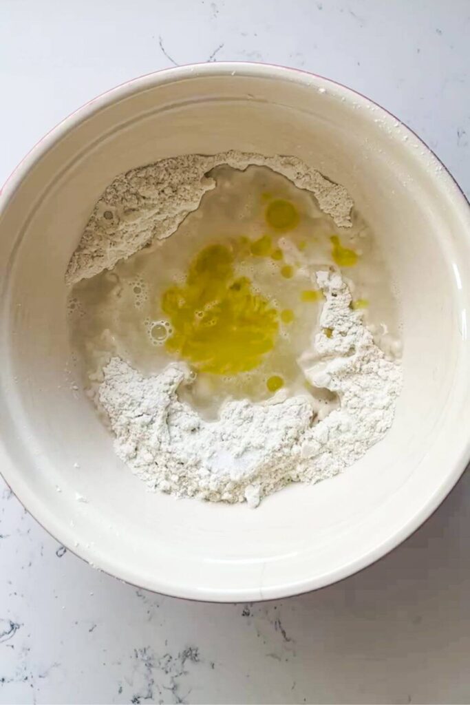 Flour, water and olive oil in a small mixing bowl.