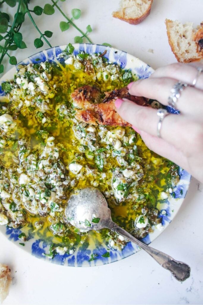 Jalapeno popper bread dipping oil on a blue and white patterned plate.