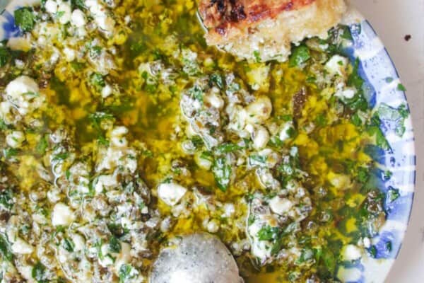 Jalapeno popper bread dipping oil on a blue and white patterned plate.