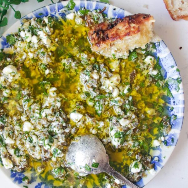 Jalapeno popper bread dipping oil on a blue and white patterned plate.