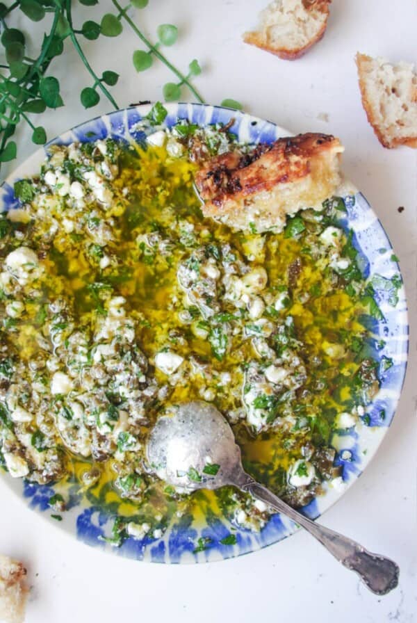Jalapeno popper bread dipping oil on a blue and white patterned plate.