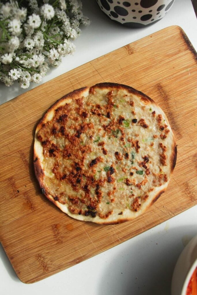 Cooked banh mi taco on a wooden board.
