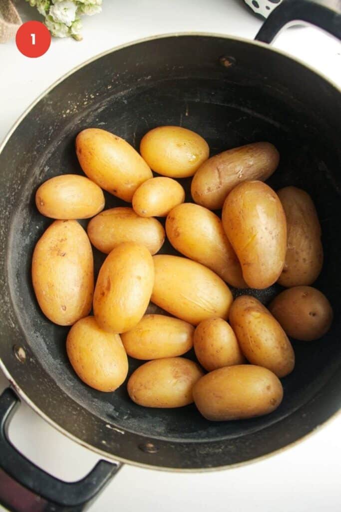 Cooked baby potatoes in a large pot.