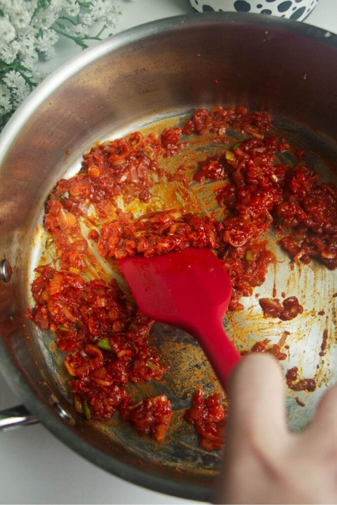 Gochujang paste cooking in a large pan.
