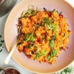 Gochujang risotto topped with scallions with sweet chilli jam on the side.