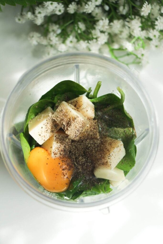 Eggs, parmesan, spinach and basil in a blender.