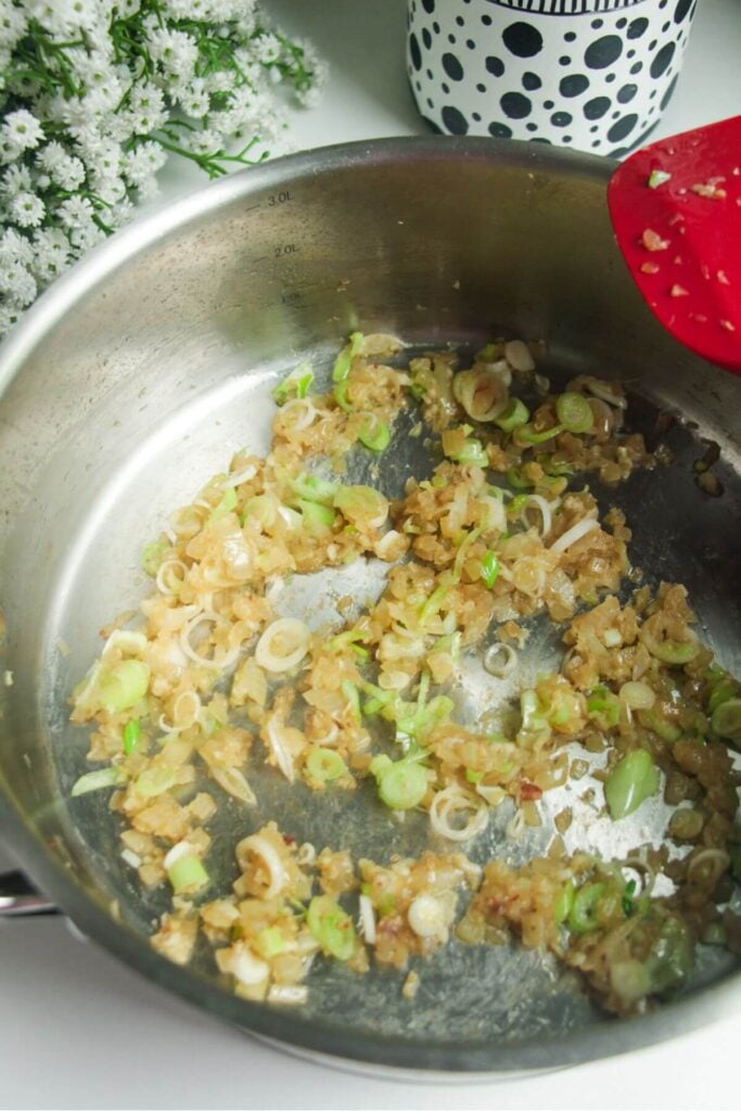 Onion, garlic and ginger cooking in a large pan.