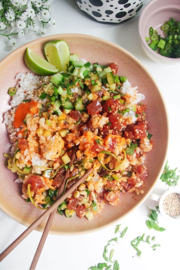 Tuna poke bowl with chopsticks on the side.
