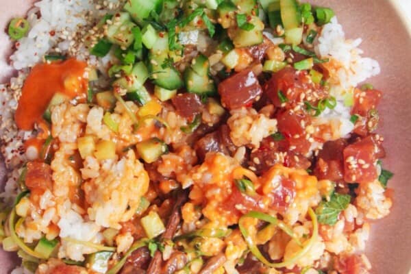 Tuna poke bowl with chopsticks on the side.
