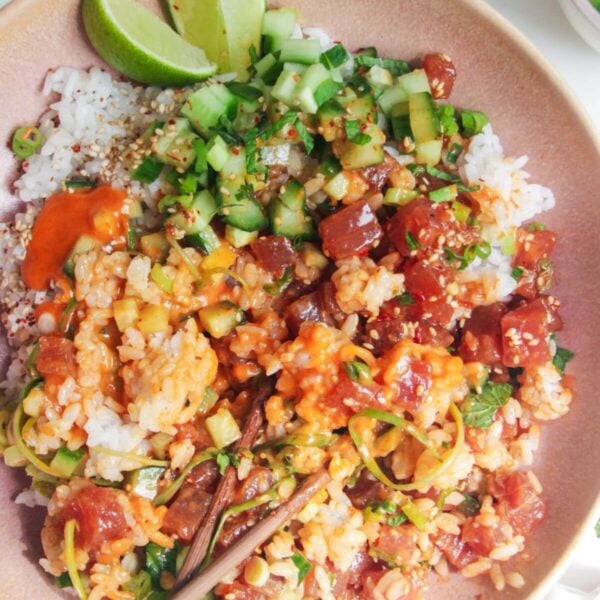 Tuna poke bowl with chopsticks on the side.