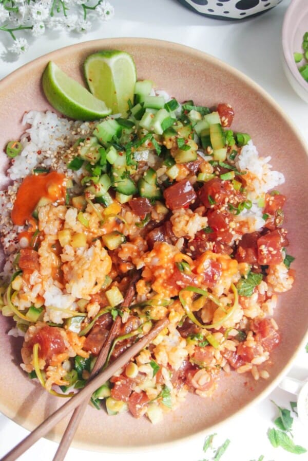 Tuna poke bowl with chopsticks on the side.