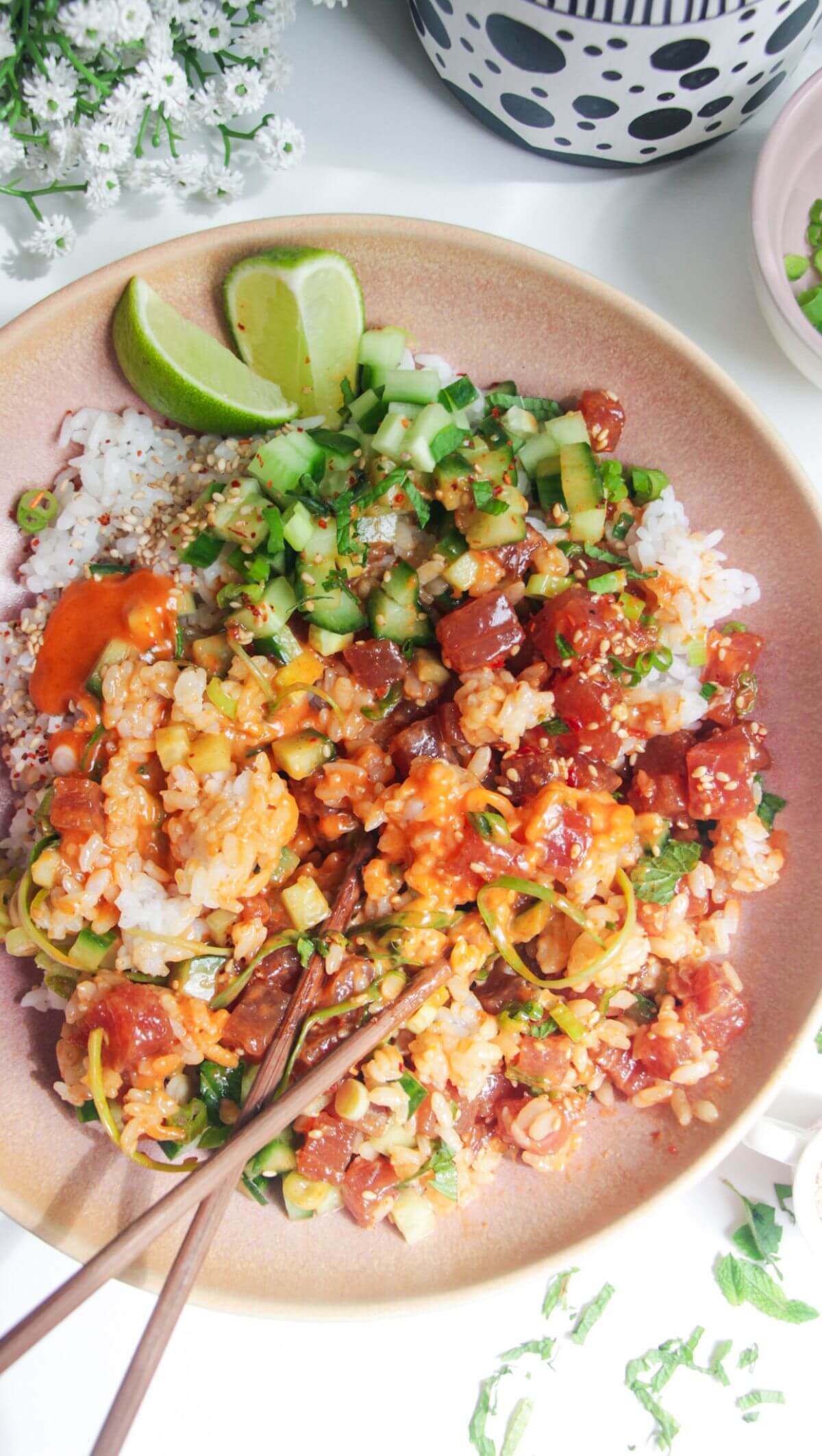 Tuna poke bowl with chopsticks on the side.