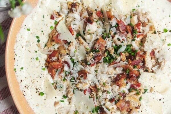 Chicken Caesar dip mixed and topped with extra chicken and bacon.