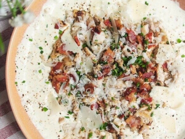 Chicken Caesar dip mixed and topped with extra chicken and bacon.
