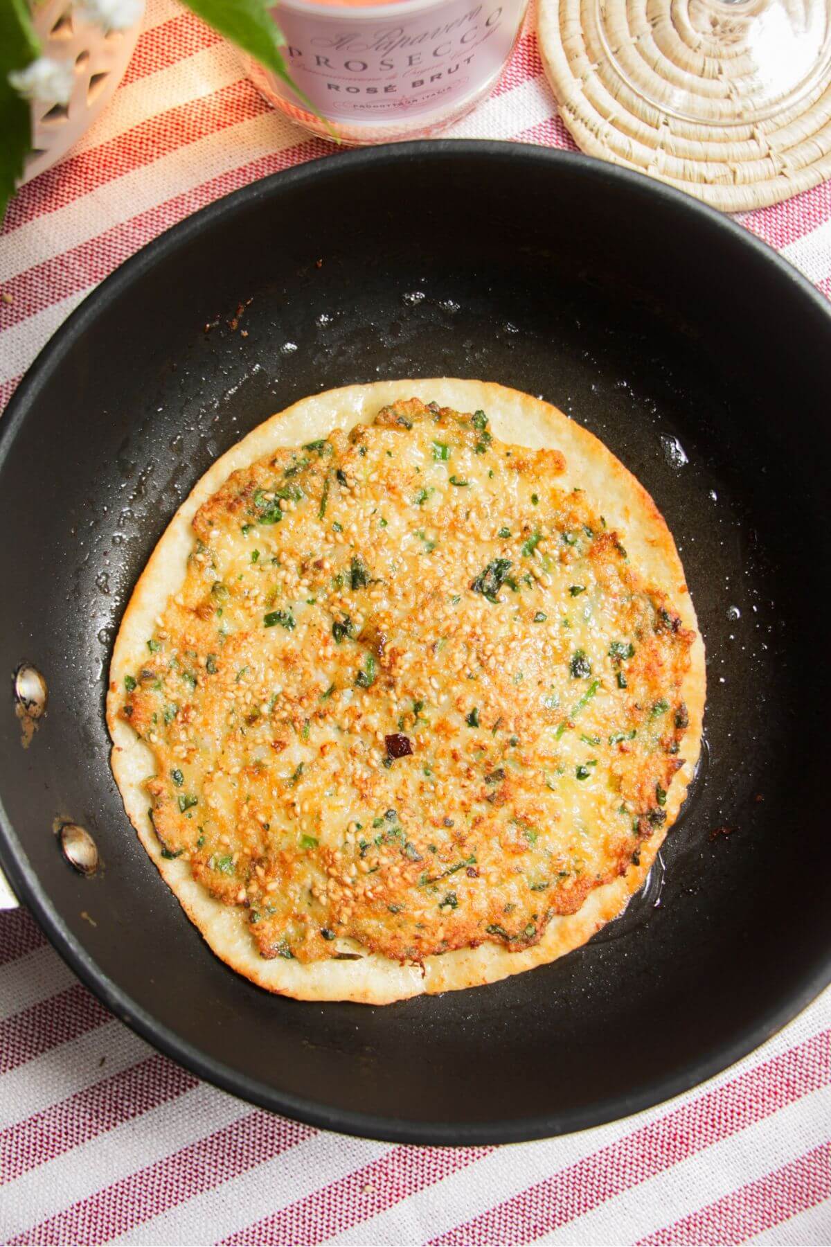 Tortilla crisping up in a small pan.