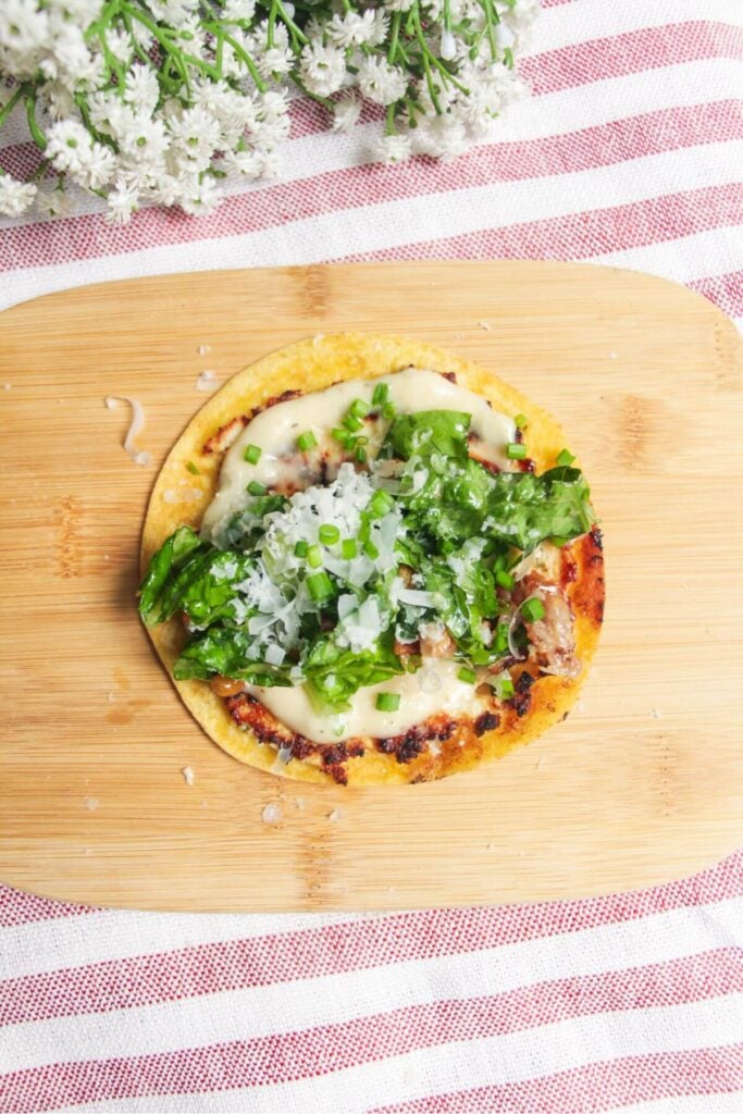 Chicken Caesar taco topped with romaine, parmesand and Caesar dressing.
