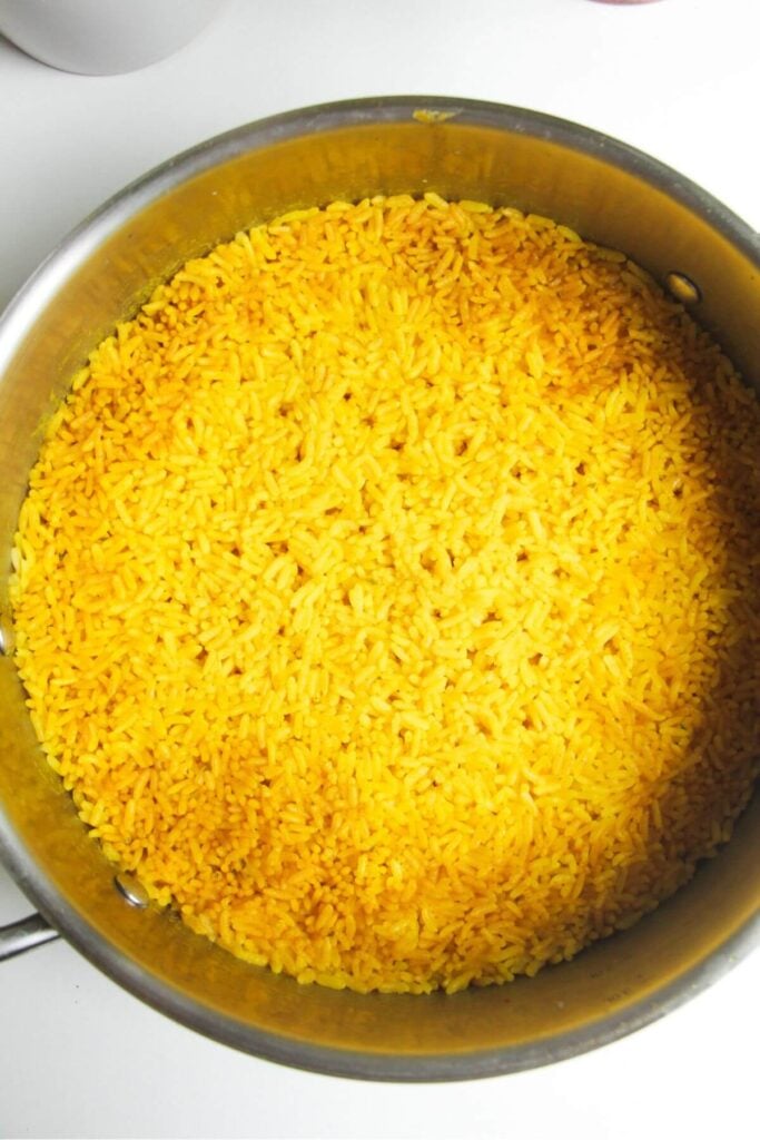 Cooked golden rice in a large pot.