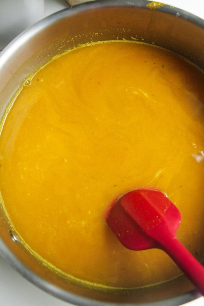 Chicken stock added to pot with rice.