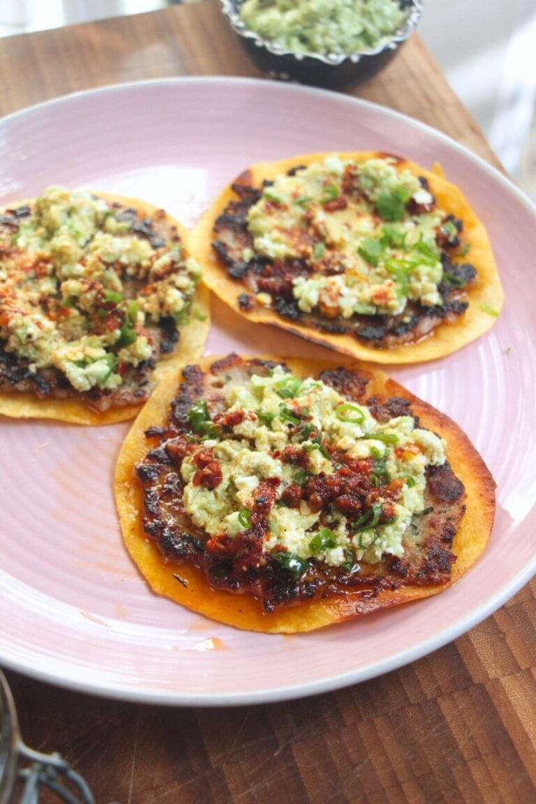 Three smash sausage tacos on a pink plate.