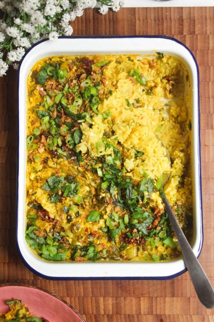 Baked loaded rice with a large silver spoon.